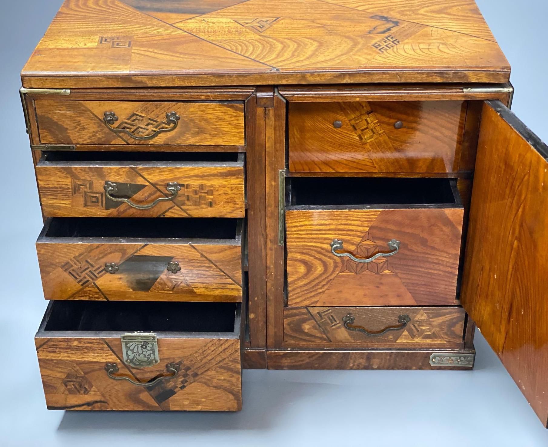 A Japanese metal mounted inlaid elm box with drawers, length 36cm